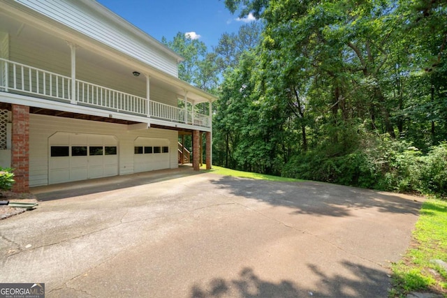 308 Golden Ct, Canton, GA 30114 - view of property exterior with concrete driveway, a garage, brick siding, and stairway