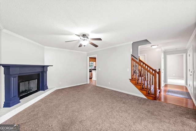 308 Golden Ct, Canton, GA 30114 - unfurnished living room featuring carpet floors, ornamental molding, ceiling fan, stairs, and a fireplace with raised hearth