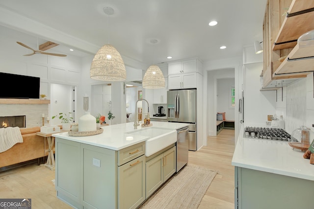 140 S Alexander Creek Rd, Newnan, GA 30263 - kitchen featuring a sink, open floor plan, light wood-style flooring, light countertops, and a ceiling fan