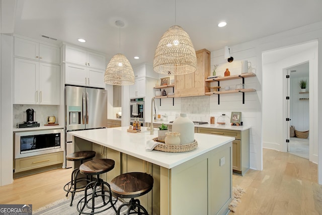 140 S Alexander Creek Rd, Newnan, GA 30263 - kitchen with stainless steel appliances, open shelves, decorative backsplash, light wood-type flooring, and light countertops