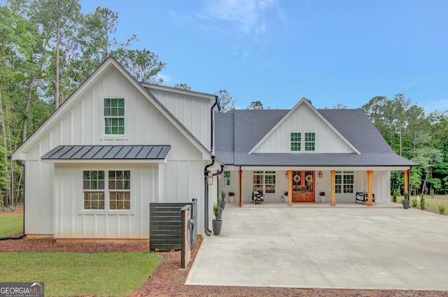 140 S Alexander Creek Rd, Newnan, GA 30263 - modern inspired farmhouse with board and batten siding, a standing seam roof, a porch, metal roof, and roof with shingles