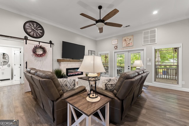 25 Wicklow Ct, Hoschton, GA 30548 - living room with a ceiling fan, wood finished floors, crown molding, a glass covered fireplace, and recessed lighting