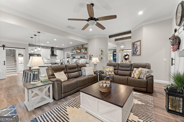 25 Wicklow Ct, Hoschton, GA 30548 - living area with ceiling fan, light wood-style flooring, recessed lighting, ornamental molding, and a barn door