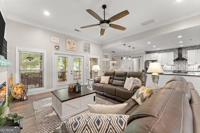 25 Wicklow Ct, Hoschton, GA 30548 - living area with a ceiling fan, crown molding, recessed lighting, light wood-type flooring, and a glass covered fireplace