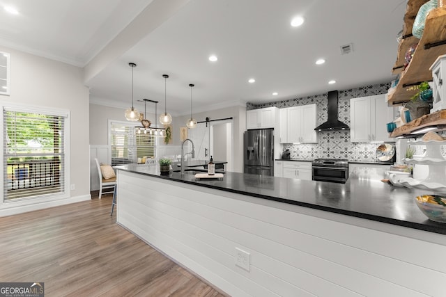 25 Wicklow Ct, Hoschton, GA 30548 - kitchen with wall chimney range hood, appliances with stainless steel finishes, open shelves, a barn door, and dark countertops