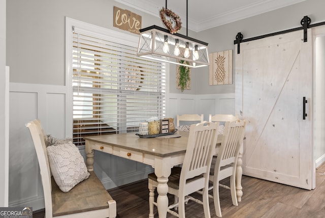 25 Wicklow Ct, Hoschton, GA 30548 - dining space featuring a decorative wall, crown molding, wood finished floors, a barn door, and a wainscoted wall