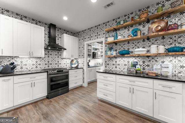 25 Wicklow Ct, Hoschton, GA 30548 - kitchen with wall chimney range hood, range with two ovens, dark countertops, open shelves, and recessed lighting