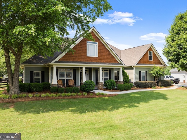 25 Wicklow Ct, Hoschton, GA 30548 - craftsman-style home featuring a front yard, a porch, and roof with shingles