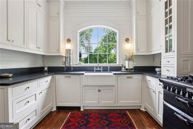 27 Sessions St NW, Marietta, GA 30060 - kitchen with dark countertops, dark wood-type flooring, a sink, and white cabinetry