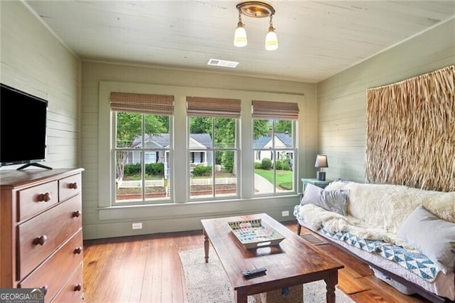 27 Sessions St NW, Marietta, GA 30060 - living room with healthy amount of natural light, light wood finished floors, and wood walls