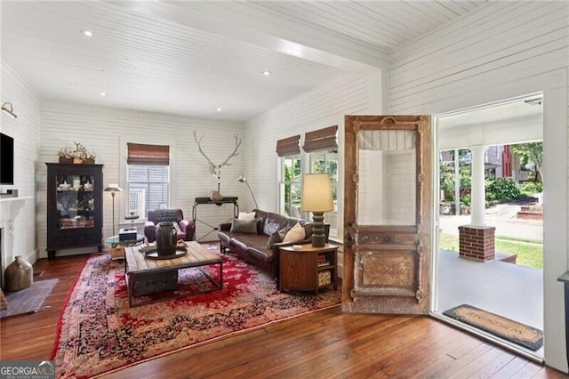 27 Sessions St NW, Marietta, GA 30060 - living room with plenty of natural light, hardwood / wood-style flooring, a fireplace with flush hearth, and decorative columns