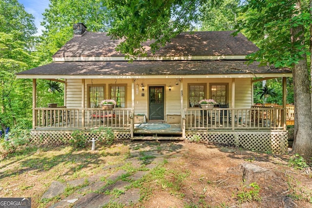 367 Woodbrier, Sautee Nacoochee, GA 30571 - view of front of home with a shingled roof, covered porch, and a chimney