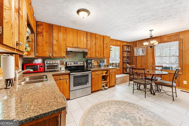 367 Woodbrier, Sautee Nacoochee, GA 30571 - kitchen featuring electric stove, under cabinet range hood, plenty of natural light, brown cabinets, and wooden walls