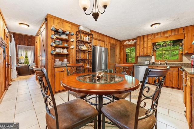 367 Woodbrier, Sautee Nacoochee, GA 30571 - dining area featuring wood walls, a textured ceiling, light tile patterned floors, and a chandelier