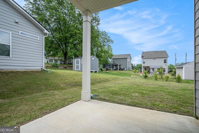 113 Waterside Dr, Calhoun, GA 30701 - view of grassy yard with a shed, a patio area, and a residential view