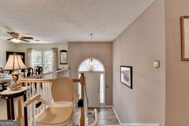1818 Mcconnell Rd, Grayson, GA 30017 - entryway featuring a chandelier, a textured ceiling, baseboards, and a ceiling fan