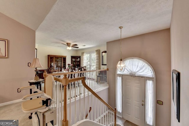 1818 Mcconnell Rd, Grayson, GA 30017 - carpeted foyer entrance with a textured ceiling, ceiling fan, and baseboards