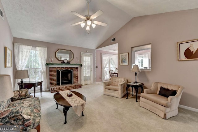 1818 Mcconnell Rd, Grayson, GA 30017 - carpeted living room featuring a ceiling fan, vaulted ceiling, a fireplace, and baseboards