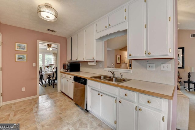 1818 Mcconnell Rd, Grayson, GA 30017 - kitchen featuring appliances with stainless steel finishes, a sink, inlaid floor details, and white cabinetry
