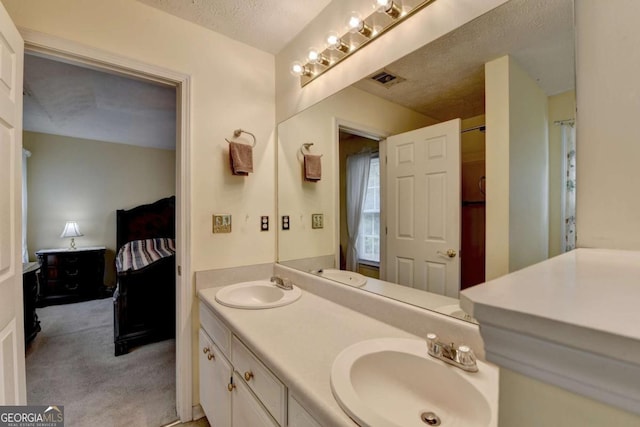 1818 Mcconnell Rd, Grayson, GA 30017 - ensuite bathroom featuring double vanity and a textured ceiling