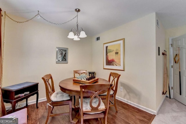 1818 Mcconnell Rd, Grayson, GA 30017 - dining area with a chandelier, baseboards, and light wood-style flooring