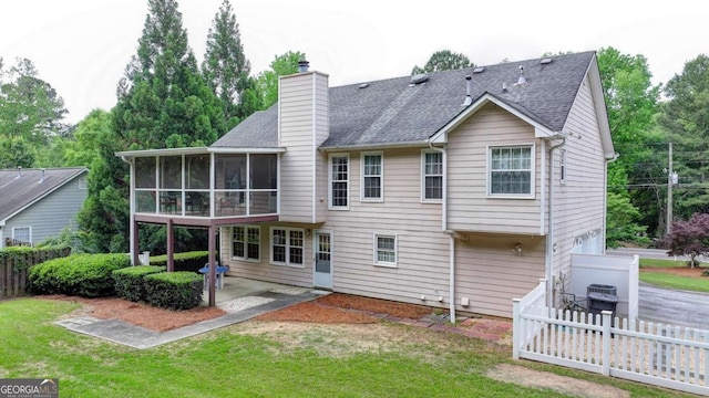 1818 Mcconnell Rd, Grayson, GA 30017 - back of property with a sunroom, a patio area, a chimney, and a shingled roof