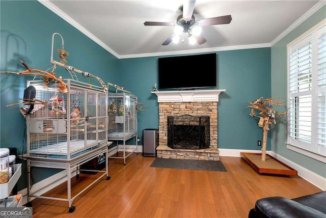 1132 Ivey Brook Dr, Bethlehem, GA 30620 - living room with wood finished floors, a ceiling fan, a fireplace, and crown molding