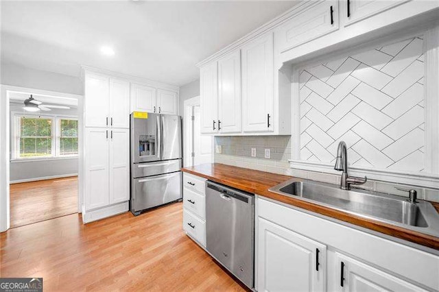 3274 Ridgecrest Rd SE, Smyrna, GA 30080 - kitchen with appliances with stainless steel finishes, a sink, tasteful backsplash, white cabinets, and recessed lighting