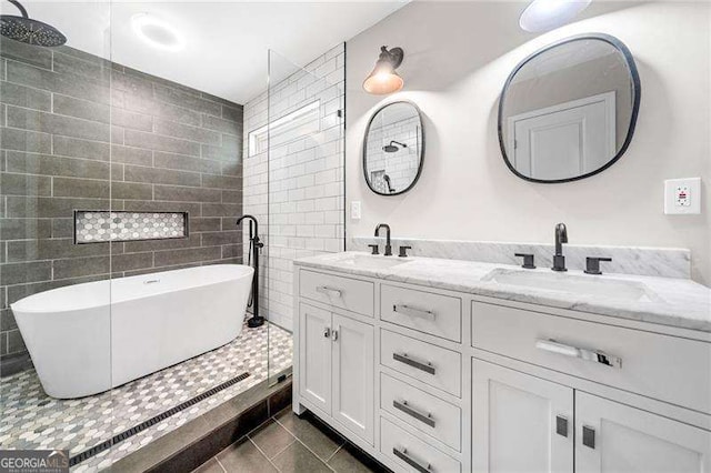 3274 Ridgecrest Rd SE, Smyrna, GA 30080 - bathroom with tile patterned flooring, double vanity, a soaking tub, and tile walls