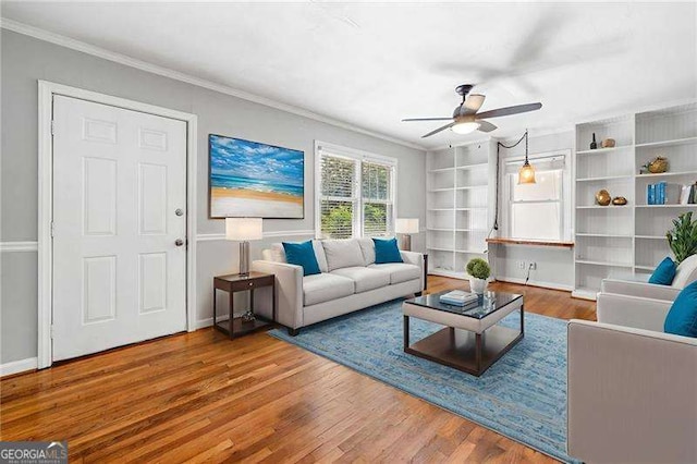 3274 Ridgecrest Rd SE, Smyrna, GA 30080 - living area with ceiling fan, wood finished floors, ornamental molding, built in shelves, and baseboards