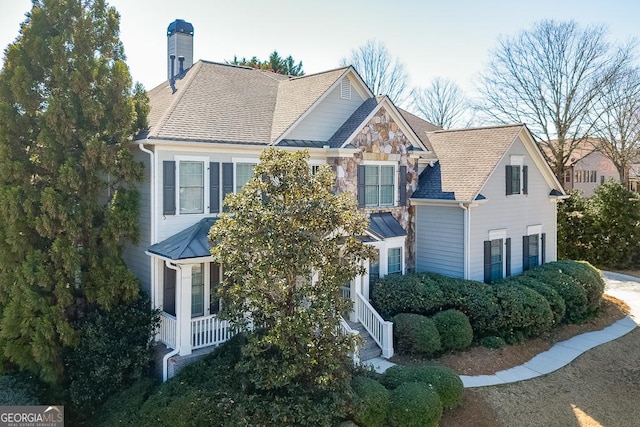 7202 Regatta Way, Flowery Branch, GA 30542 - view of front facade with stone siding, a chimney, and a shingled roof