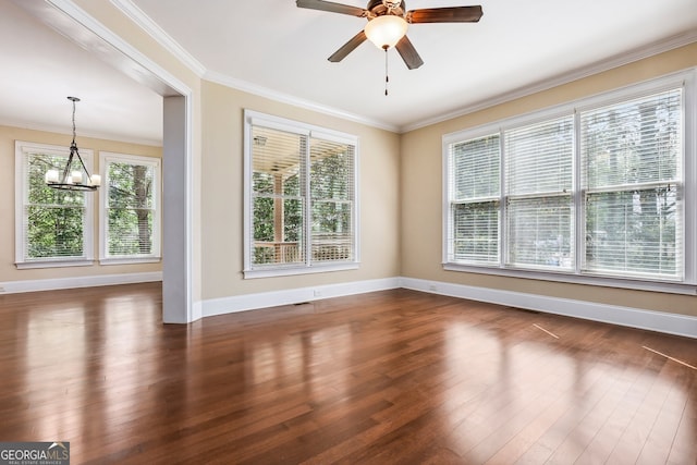 189 Privet Cir, Suwanee, GA 30024 - spare room featuring a chandelier, baseboards, dark wood finished floors, ornamental molding, and a ceiling fan