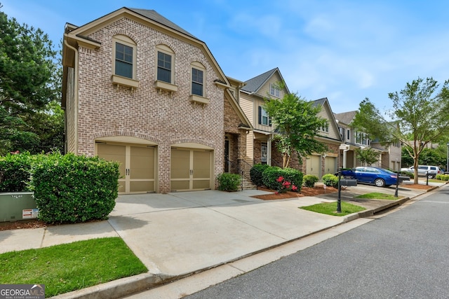 189 Privet Cir, Suwanee, GA 30024 - view of front of home with brick siding, a garage, concrete driveway, and a residential view