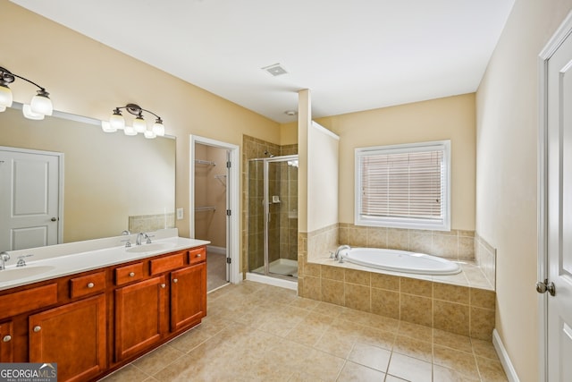 189 Privet Cir, Suwanee, GA 30024 - full bath featuring tile patterned floors, a stall shower, a bath, double vanity, and a spacious closet