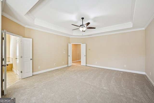 189 Privet Cir, Suwanee, GA 30024 - unfurnished bedroom with a tray ceiling, crown molding, light carpet, baseboards, and connected bathroom
