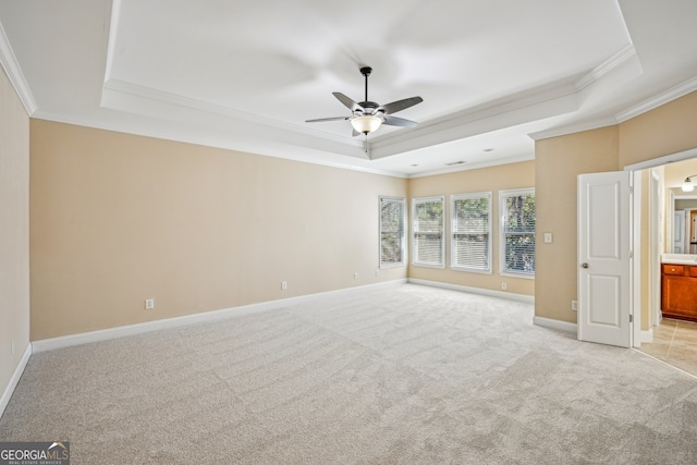 189 Privet Cir, Suwanee, GA 30024 - empty room featuring a raised ceiling, ceiling fan, light colored carpet, ornamental molding, and baseboards