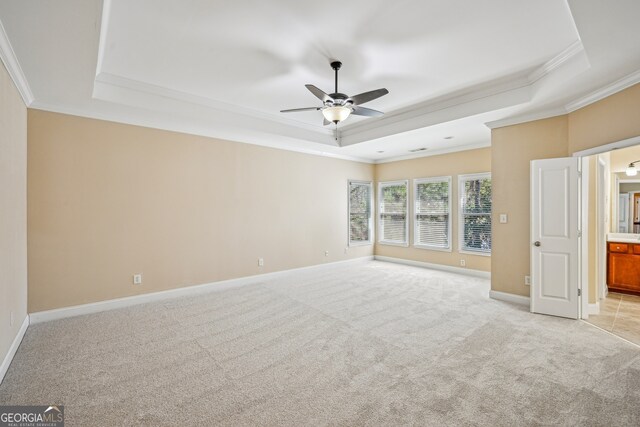 189 Privet Cir, Suwanee, GA 30024 - empty room featuring a tray ceiling, ornamental molding, a ceiling fan, and light carpet