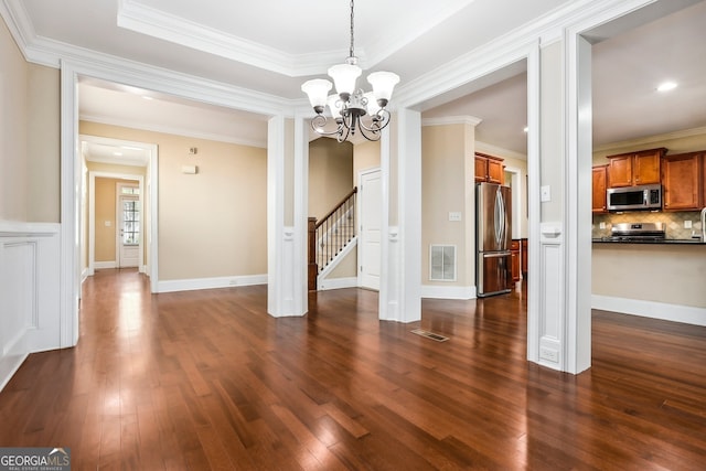 189 Privet Cir, Suwanee, GA 30024 - unfurnished dining area with dark wood-style floors, a chandelier, ornamental molding, and stairway