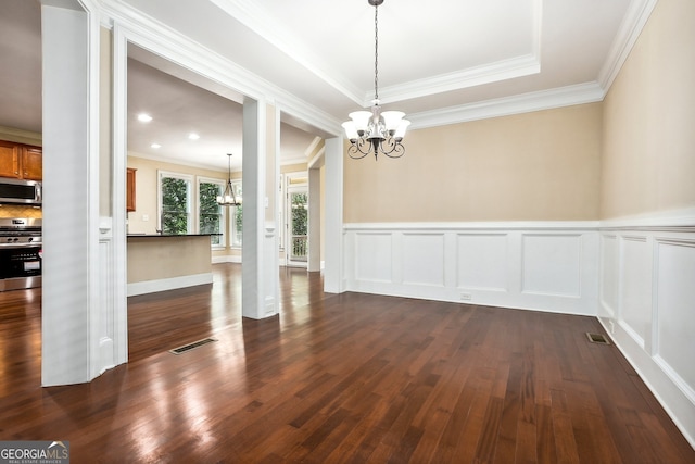 189 Privet Cir, Suwanee, GA 30024 - unfurnished dining area with a chandelier, ornamental molding, dark wood-style floors, wainscoting, and a decorative wall