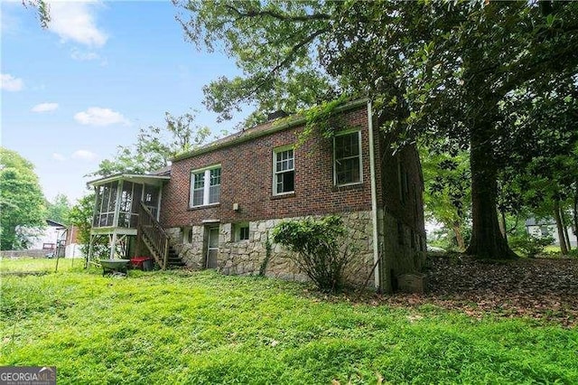 1699 Emerald Ave SW, Atlanta, GA 30310 - rear view of property with stone siding, stairs, a sunroom, a lawn, and brick siding