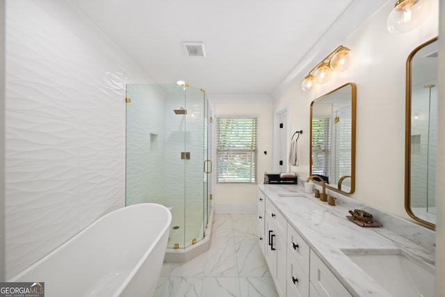 308 Reed St, Scottdale, GA 30079 - bathroom featuring marble look tiles, a freestanding tub, double vanity, and a shower stall