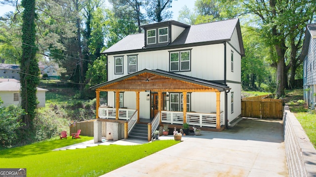 308 Reed St, Scottdale, GA 30079 - view of front facade with covered porch, concrete driveway, and a front lawn