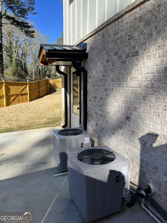 308 Reed St, Scottdale, GA 30079 - exterior view of a central AC unit and board and batten siding