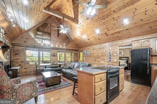 573 Hiawatha Trl, Blue Ridge, GA 30513 - kitchen featuring black appliances, wooden walls, ceiling fan, high vaulted ceiling, and open floor plan