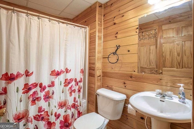 573 Hiawatha Trl, Blue Ridge, GA 30513 - bathroom with wood walls, a sink, shower / bath combination with curtain, and toilet