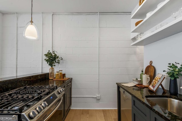 820 Dekalb Ave NE Unit 2, Atlanta, GA 30307 - kitchen featuring stainless steel appliances, dark stone counters, light wood-style flooring, pendant lighting, and open shelves