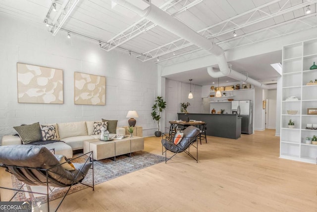 820 Dekalb Ave NE Unit 2, Atlanta, GA 30307 - living room with light wood-type flooring and concrete block wall