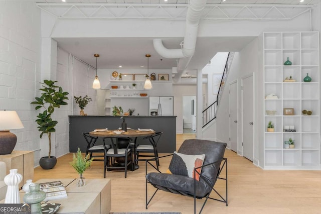 820 Dekalb Ave NE Unit 2, Atlanta, GA 30307 - living room with light wood-style flooring, stairway, and concrete block wall