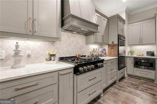 131 Forsyth Park Ln, Woodstock, GA 30188 - kitchen featuring wall chimney exhaust hood, black appliances, ornamental molding, gray cabinets, and backsplash