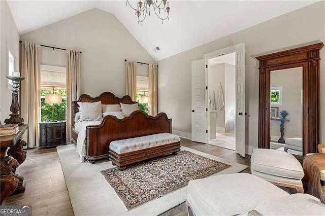 131 Forsyth Park Ln, Woodstock, GA 30188 - bedroom featuring lofted ceiling, multiple windows, light wood-style flooring, a chandelier, and baseboards
